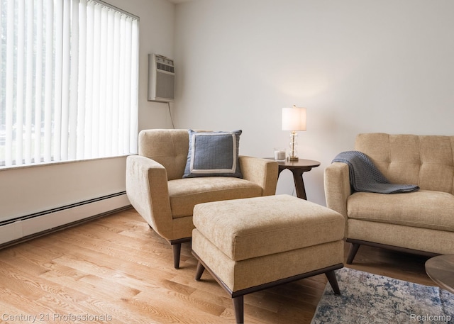 5959 Alan Dr # 56, Brighton, MI 48116 - living area with plenty of natural light, light wood-style floors, a wall unit AC, and a baseboard radiator