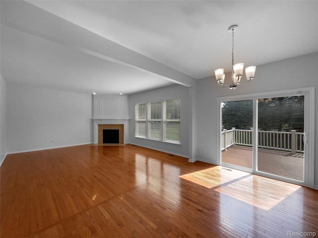 1960 Frances Way, Ypsilanti, MI 48198 - unfurnished living room featuring a chandelier, wood finished floors, and a fireplace with flush hearth