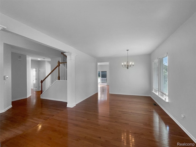 1960 Frances Way, Ypsilanti, MI 48198 - unfurnished living room with a chandelier, healthy amount of natural light, wood finished floors, and stairs