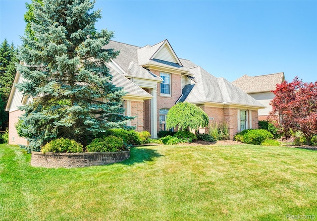 13381 Latheron Dr, Plymouth, MI 48170 - traditional-style home featuring brick siding, a front lawn, and roof with shingles