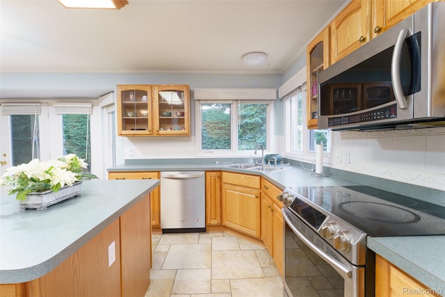 13381 Latheron Dr, Plymouth, MI 48170 - kitchen with stainless steel appliances, ornamental molding, glass insert cabinets, stone tile floors, and light countertops