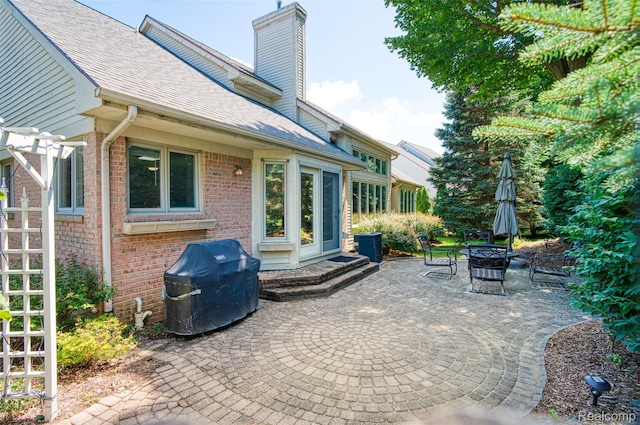 13381 Latheron Dr, Plymouth, MI 48170 - view of patio with a grill and an outdoor fire pit