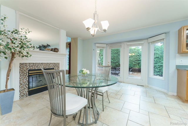 13381 Latheron Dr, Plymouth, MI 48170 - dining area featuring a tile fireplace, a chandelier, and stone tile flooring