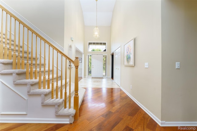13381 Latheron Dr, Plymouth, MI 48170 - entryway with a high ceiling, wood finished floors, and stairs