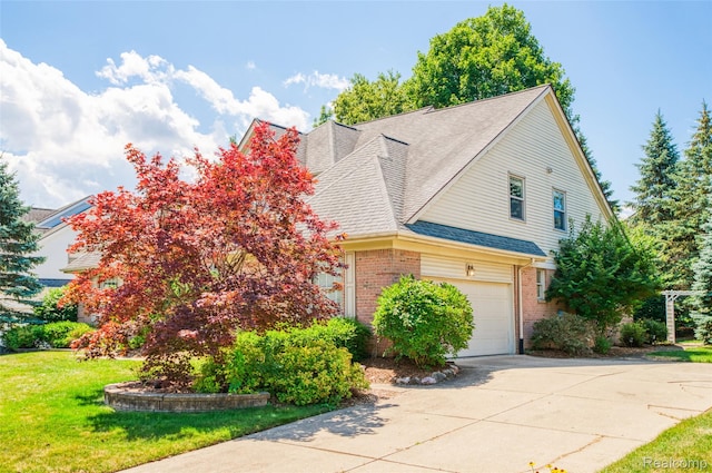 13381 Latheron Dr, Plymouth, MI 48170 - view of front of property with brick siding, driveway, a front lawn, roof with shingles, and an attached garage