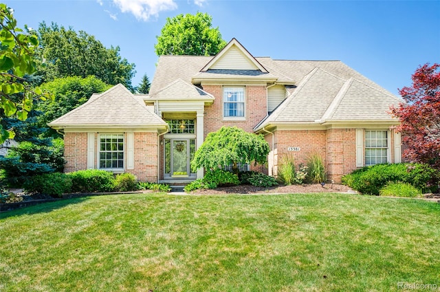 13381 Latheron Dr, Plymouth, MI 48170 - view of front of house featuring a front lawn, brick siding, and roof with shingles