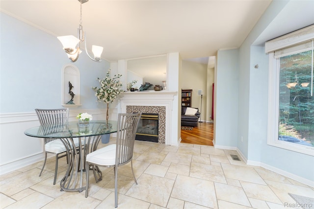 13381 Latheron Dr, Plymouth, MI 48170 - dining space with a tile fireplace, a chandelier, and stone finish floors
