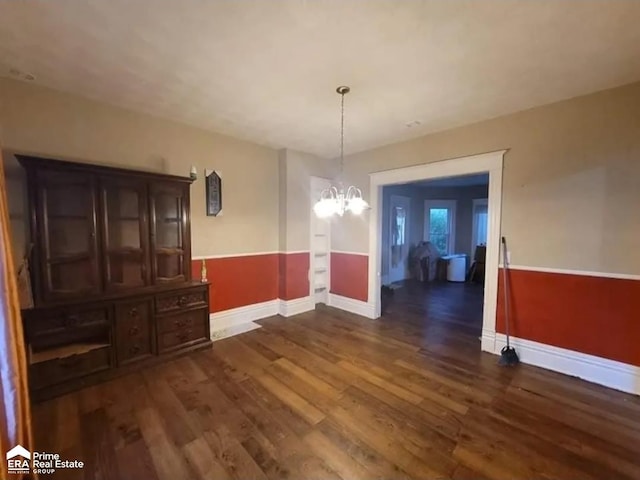 108 N Mercer St, Durand, MI 48429 - unfurnished dining area with a chandelier, dark wood-style floors, and wainscoting