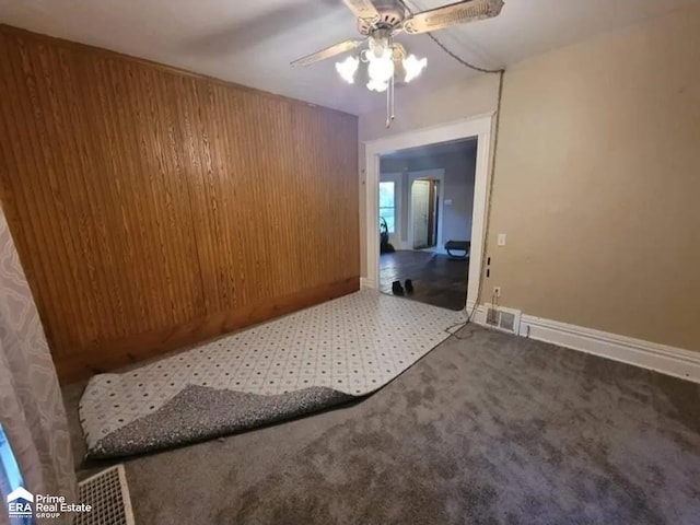 108 N Mercer St, Durand, MI 48429 - unfurnished room with a ceiling fan, carpet floors, and wooden walls