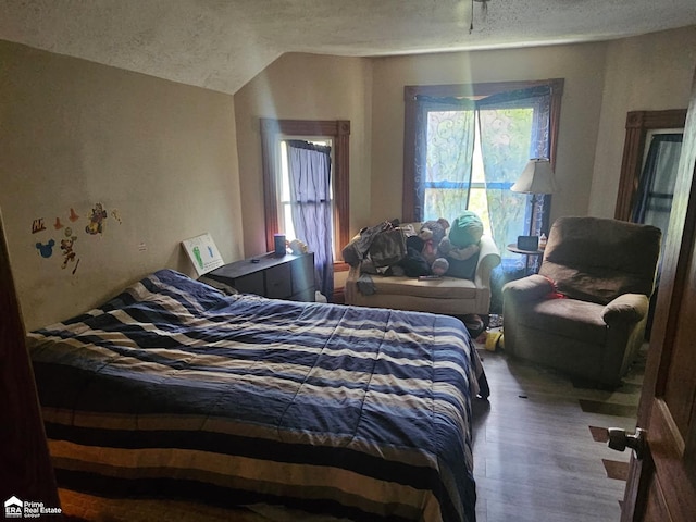 108 N Mercer St, Durand, MI 48429 - bedroom with a textured ceiling and wood finished floors