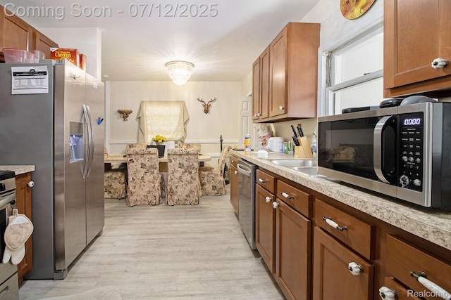 26651 Shiawassee Rd, Southfield, MI 48033 - kitchen with appliances with stainless steel finishes, brown cabinets, and light countertops
