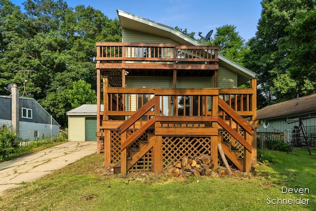 65 Sundago Park St, Hastings, MI 49058 - back of property featuring stairway, a wooden deck, and a lawn