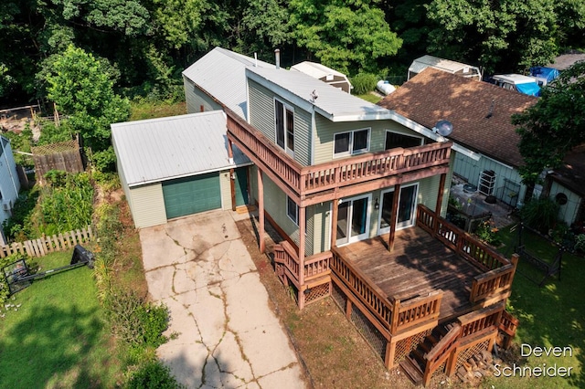 65 Sundago Park St, Hastings, MI 49058 - rear view of property featuring a garage, concrete driveway, and a deck