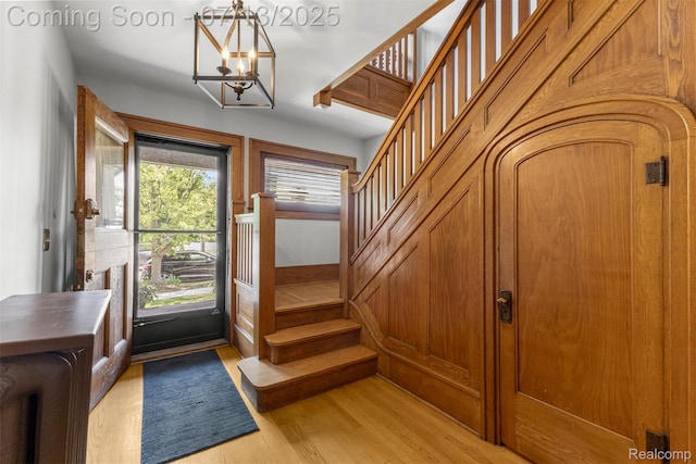 830 S Brady Rd, Dearborn, MI 48124 - entrance foyer featuring stairway, light wood-type flooring, and a chandelier