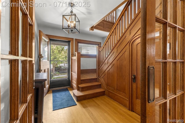 830 S Brady Rd, Dearborn, MI 48124 - foyer entrance featuring stairway, light wood-style floors, and a chandelier