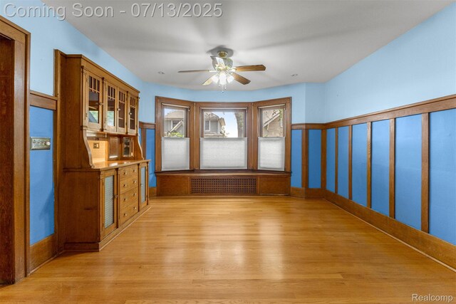 830 S Brady Rd, Dearborn, MI 48124 - spare room featuring radiator heating unit, light wood-type flooring, and a ceiling fan