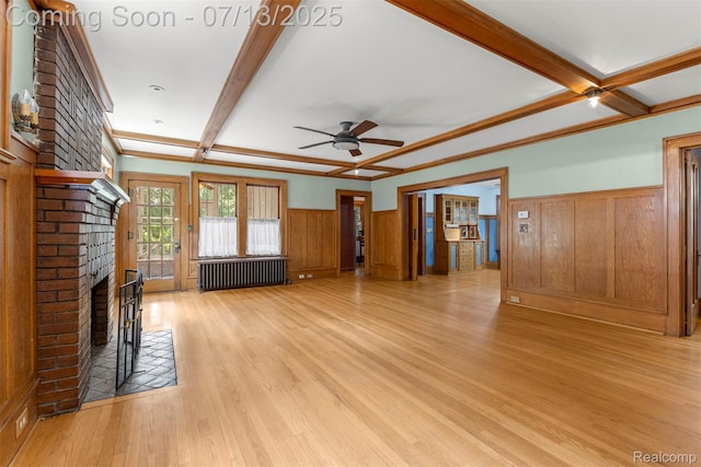 830 S Brady Rd, Dearborn, MI 48124 - unfurnished living room with radiator, a wainscoted wall, beamed ceiling, a ceiling fan, and light wood-type flooring
