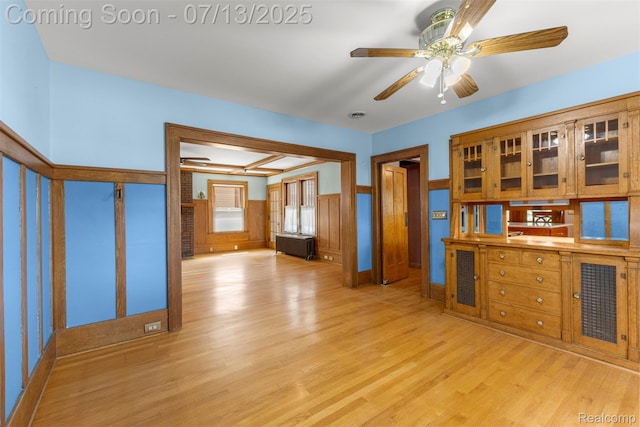 830 S Brady Rd, Dearborn, MI 48124 - kitchen with light wood finished floors, a ceiling fan, wainscoting, and glass insert cabinets