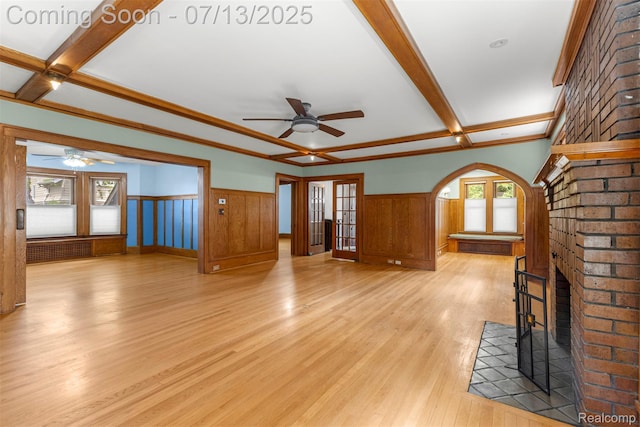 830 S Brady Rd, Dearborn, MI 48124 - unfurnished living room featuring a ceiling fan, wainscoting, light wood-style flooring, radiator heating unit, and beamed ceiling