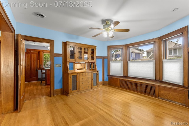 830 S Brady Rd, Dearborn, MI 48124 - empty room with light wood-style flooring, radiator, and a ceiling fan