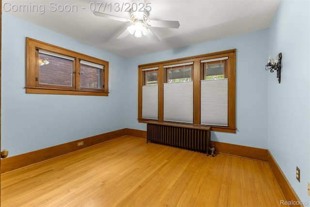 830 S Brady Rd, Dearborn, MI 48124 - spare room with radiator, light wood-type flooring, and ceiling fan