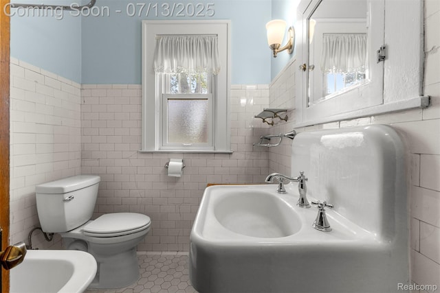 830 S Brady Rd, Dearborn, MI 48124 - bathroom featuring tile walls, a bidet, wainscoting, and tile patterned floors