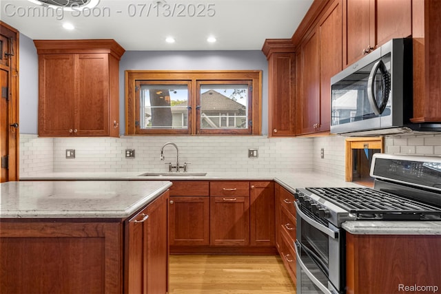 830 S Brady Rd, Dearborn, MI 48124 - kitchen with appliances with stainless steel finishes, light stone counters, light wood-type flooring, decorative backsplash, and recessed lighting