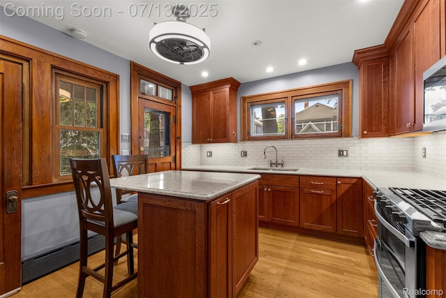 830 S Brady Rd, Dearborn, MI 48124 - kitchen with a baseboard radiator, appliances with stainless steel finishes, backsplash, light stone counters, and recessed lighting