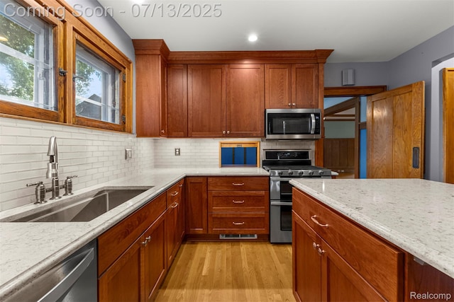 830 S Brady Rd, Dearborn, MI 48124 - kitchen featuring appliances with stainless steel finishes, light wood finished floors, light stone counters, tasteful backsplash, and recessed lighting