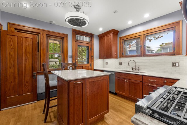 830 S Brady Rd, Dearborn, MI 48124 - kitchen featuring appliances with stainless steel finishes, decorative backsplash, light wood-style floors, a center island, and recessed lighting
