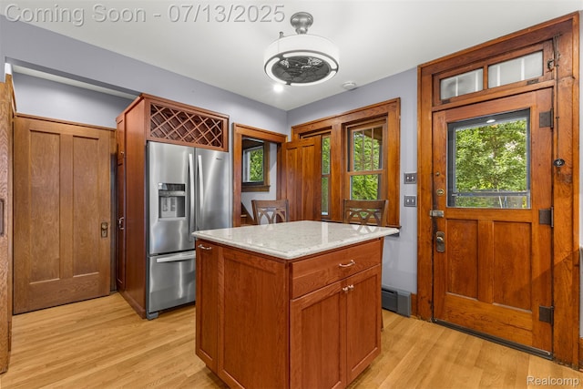 830 S Brady Rd, Dearborn, MI 48124 - kitchen featuring stainless steel refrigerator with ice dispenser, light wood-type flooring, a center island, and light stone counters