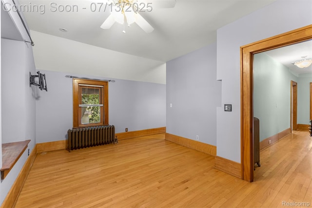 830 S Brady Rd, Dearborn, MI 48124 - spare room with radiator, ceiling fan, light wood-style floors, and vaulted ceiling