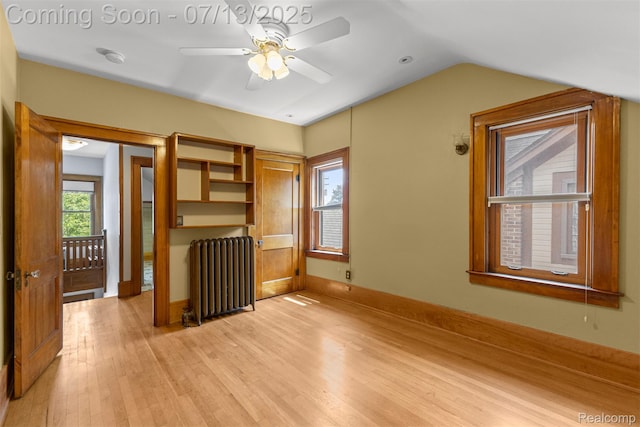 830 S Brady Rd, Dearborn, MI 48124 - spare room with radiator heating unit, light wood finished floors, vaulted ceiling, and ceiling fan