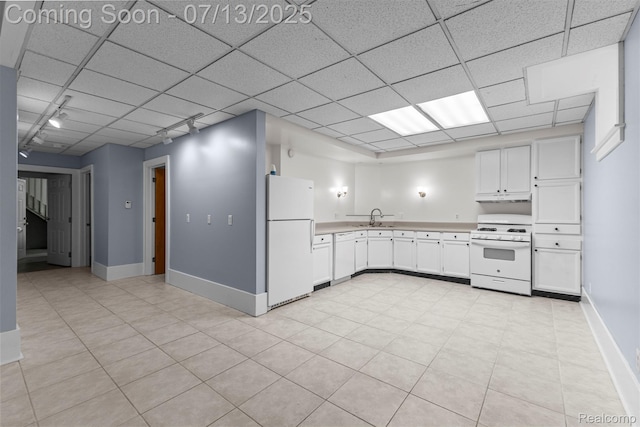 830 S Brady Rd, Dearborn, MI 48124 - kitchen featuring white appliances, light countertops, white cabinetry, under cabinet range hood, and a paneled ceiling
