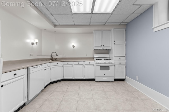 830 S Brady Rd, Dearborn, MI 48124 - kitchen featuring white appliances, under cabinet range hood, a drop ceiling, light countertops, and white cabinetry