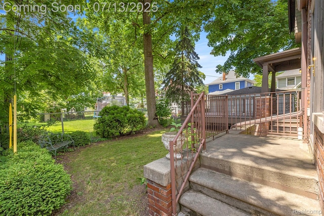 830 S Brady Rd, Dearborn, MI 48124 - fenced backyard featuring a wooden deck and stairs