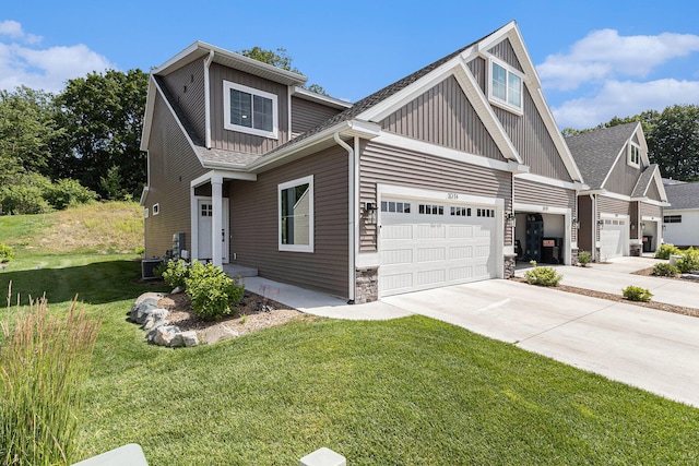 1014 Castlebay Way Unit 8, Hudsonville, MI 49426 - craftsman house with board and batten siding, concrete driveway, a front yard, a garage, and stone siding