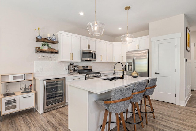 1014 Castlebay Way Unit 8, Hudsonville, MI 49426 - kitchen with beverage cooler, stainless steel appliances, open shelves, backsplash, and recessed lighting