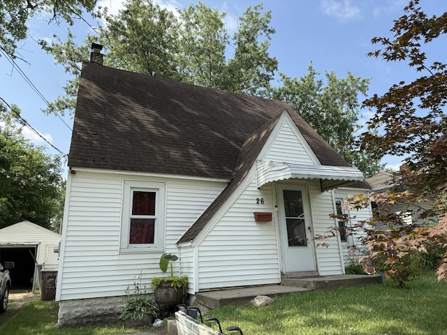 26 Edna Ave, Pontiac, MI 48341 - view of front of property featuring roof with shingles, a chimney, and an outbuilding