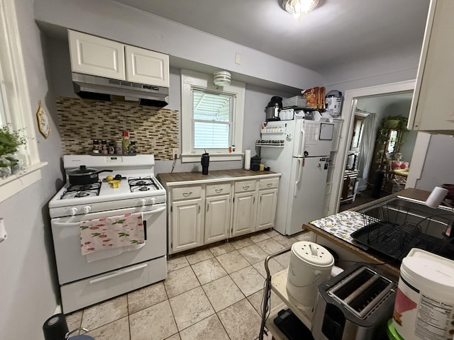 26 Edna Ave, Pontiac, MI 48341 - kitchen with white appliances, tasteful backsplash, under cabinet range hood, light tile patterned flooring, and white cabinets