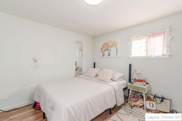 961 Dolphin St SW Unit 013, Wyoming, MI 49509 - bedroom with wood finished floors and baseboards