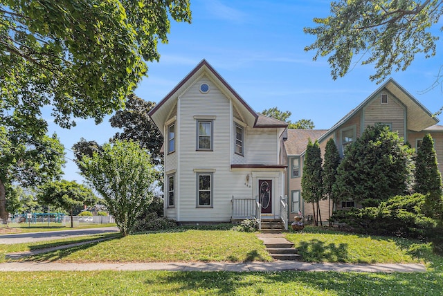 449 4th St, Manistee, MI 49660 - view of front facade featuring a front yard