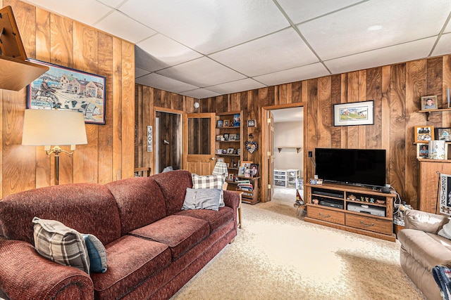 449 4th St, Manistee, MI 49660 - carpeted living room with wooden walls and a paneled ceiling