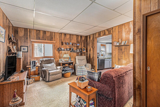 449 4th St, Manistee, MI 49660 - carpeted living room with wooden walls and a drop ceiling