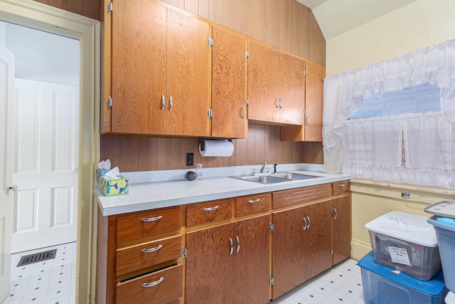 449 4th St, Manistee, MI 49660 - kitchen featuring light floors, light countertops, and brown cabinetry