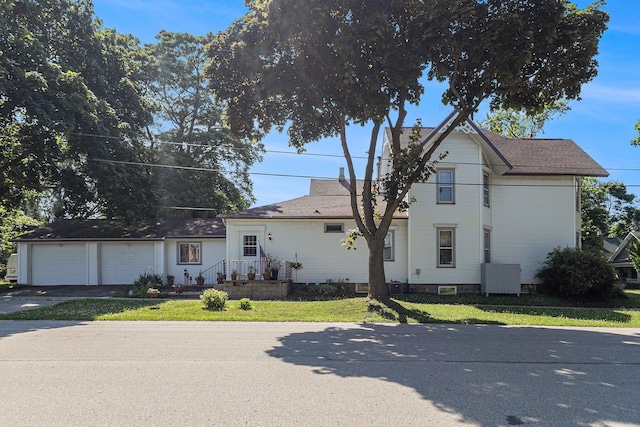 449 4th St, Manistee, MI 49660 - view of front of home with concrete driveway and an attached garage
