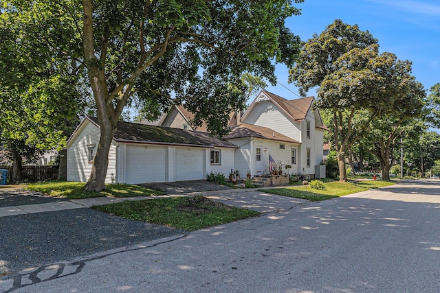 449 4th St, Manistee, MI 49660 - victorian-style house featuring a garage and driveway