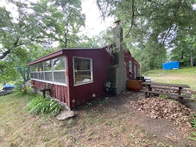 2031 E Oak St, Newaygo, MI 49337 - view of property exterior featuring a chimney and a sunroom
