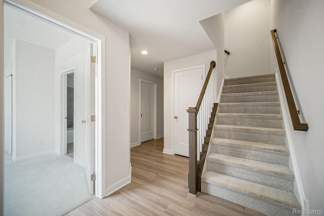 2965 Aughton Rd, Ann Arbor, MI 48105 - stairway with wood finished floors and recessed lighting