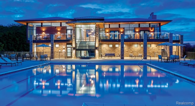 2965 Aughton Rd, Ann Arbor, MI 48105 - back of house with a balcony, a patio area, and a community pool